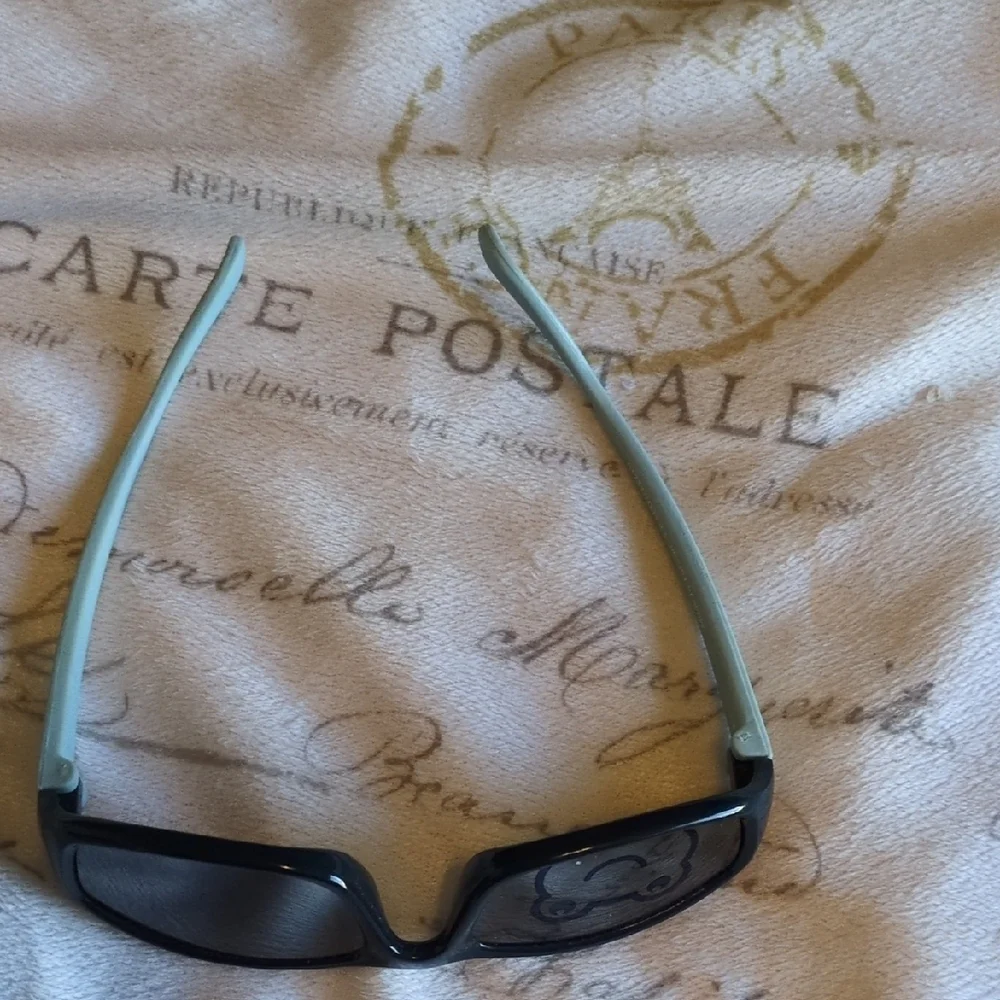 Black And Blue Baby Sunglasses With A Sleek Design Of A Frog On One Of The Lense